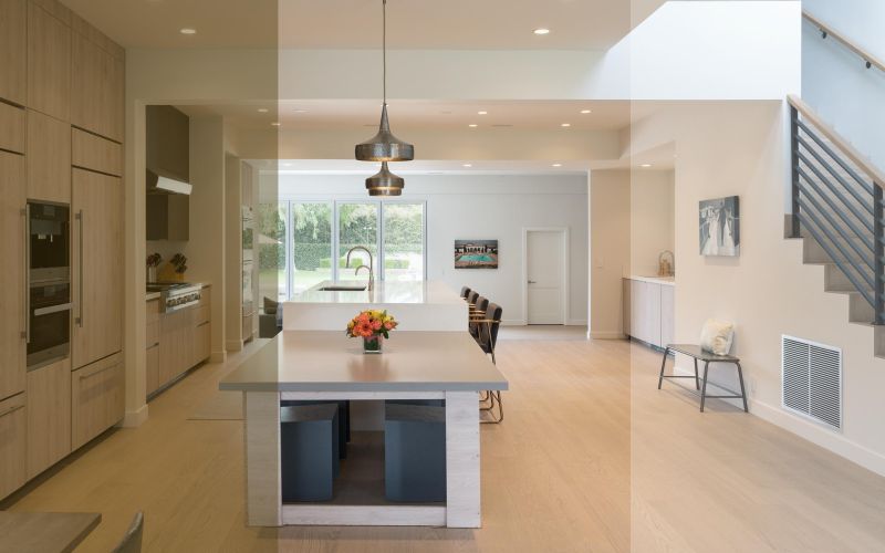 Open kitchen split between warm and cool Ketra tunable white lighting in a luxury home