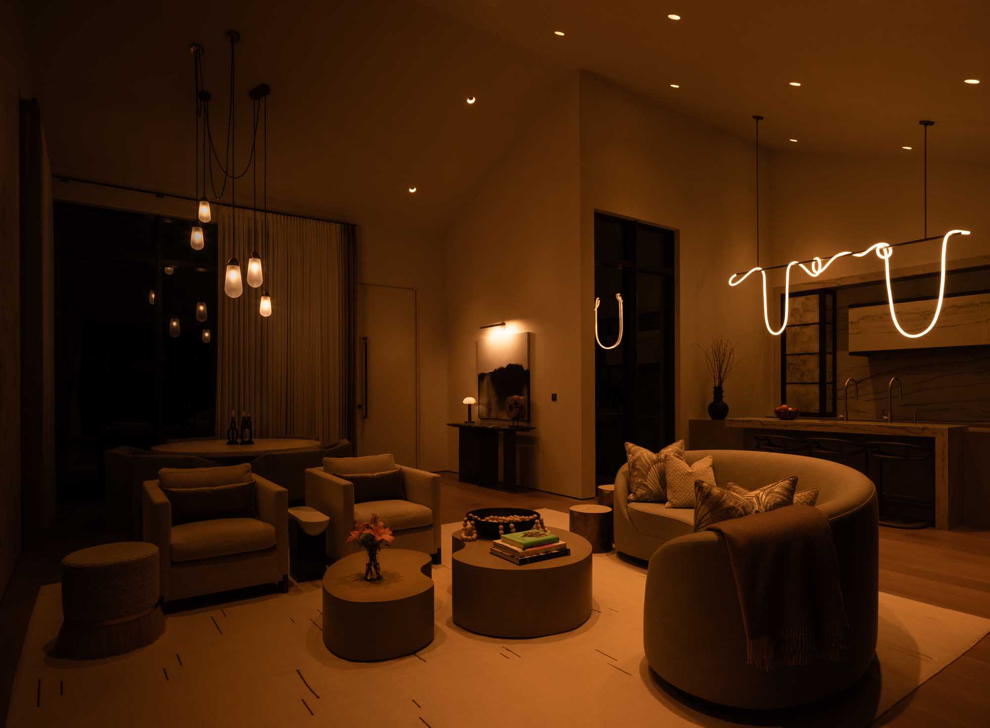 Dimmed warm Lutron lighting creating a cozy evening living room scene.