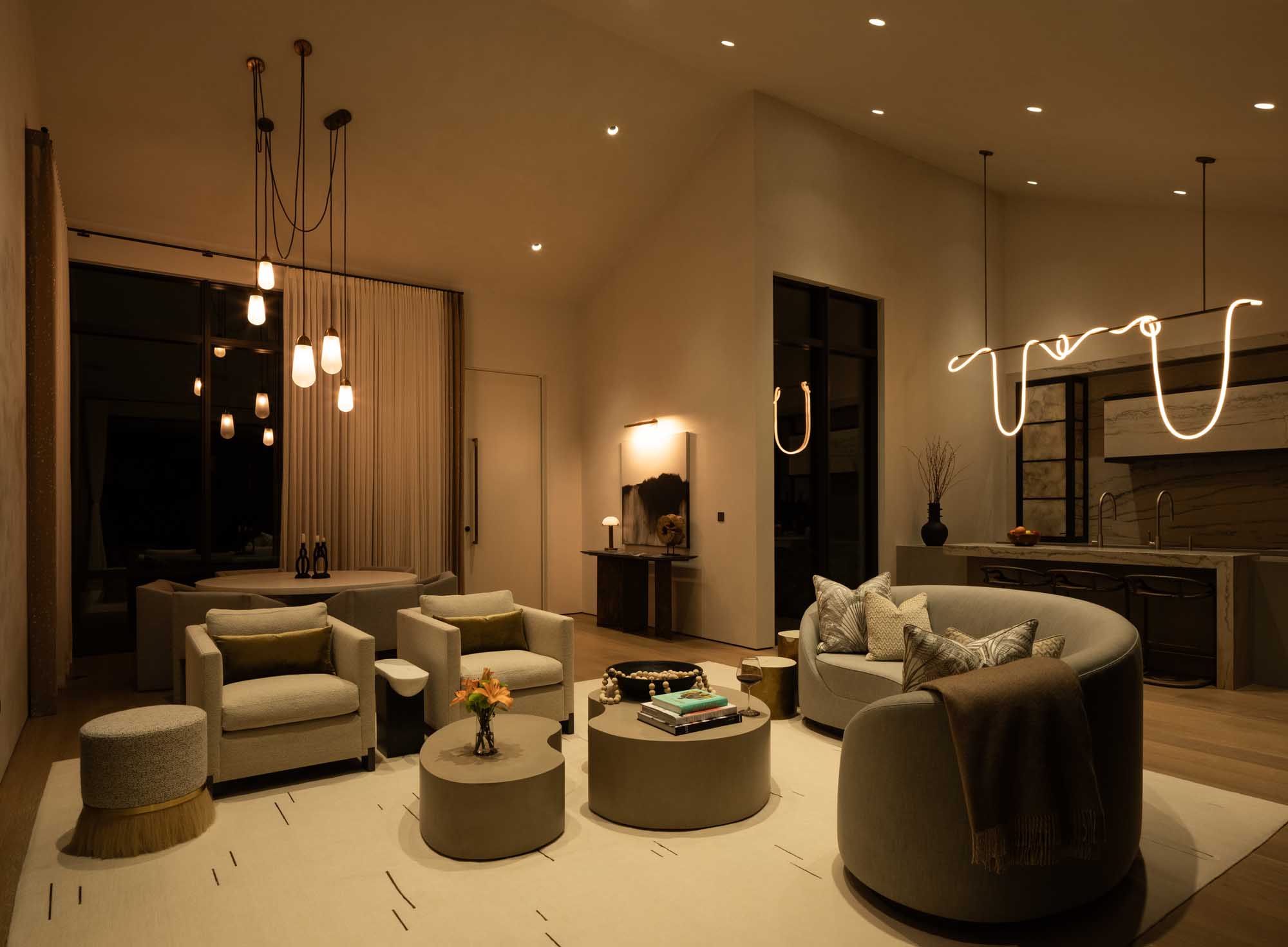 Evening living room illuminated by soft Lutron linear and cove lighting.