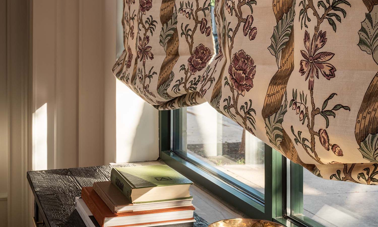 Lutron Roman shade featuring a vintage floral and ribbon fabric design.